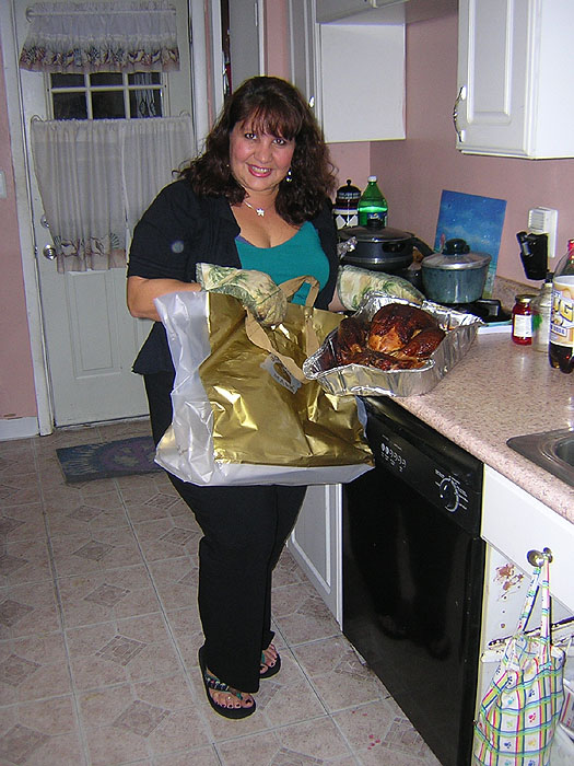 Theresa pulls a turkey from a bag